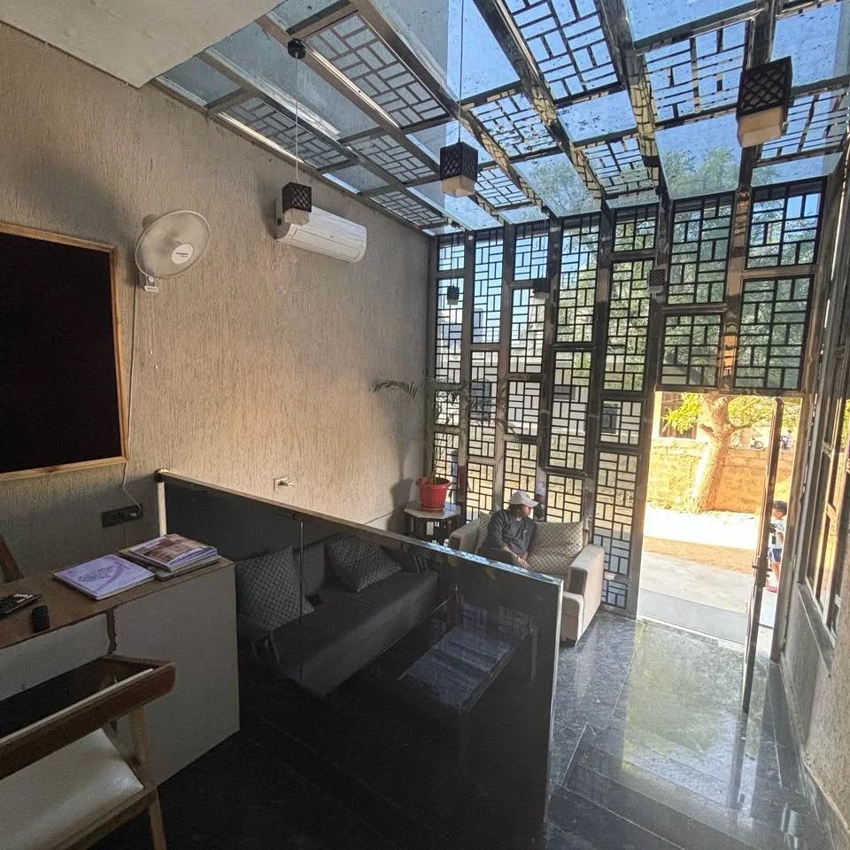 Light-filled residents' lounge with lattice screen
