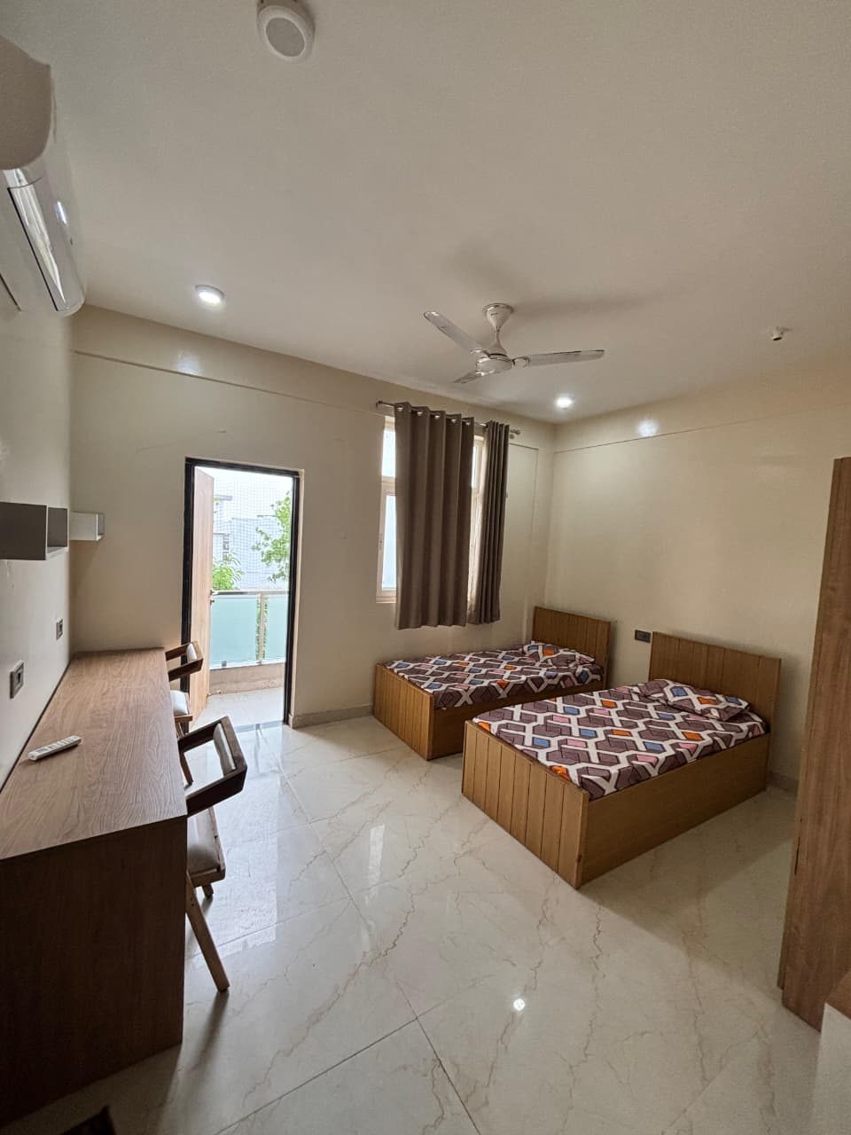 A furnished twin-sharing room with natural light